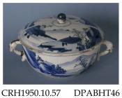 Bowl, and cover, hard paste porcelain,  with two dragon mask scroll handles and ball knop, decorated with blue painted landscape panels; not marked, made in Jingdezhen, Jiangxi Province, China, c1662-75
