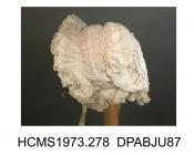 Baby's cap, fine linen, two pairs of drawstrings 2cm apart round face, 7.5cm diameter crown pieced from scraps of whitework, three 3cm frills round face of net darned to look like lille lace, double frill of net round nape, ribbon ties, crown made from 