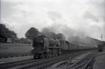 Digital image copy at 800 dpi of an original black and white print photograph retained by donor of Mike Peart, showing a rebuilt West Country class locomotive 34047 "CALLINGTON" at Micheldever Station with express from Bournemouth to London Waterloo.
