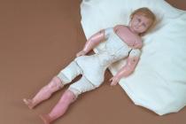 Doll, wax head with blue glass eyes and hand painted features, blonde hair inserted into head, stuffed fabric body with wax arms and lower legs, late 19th century