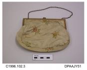 Bag, small, evening, cream satin brocaded rose sprigs in pastel shades, lined peach fabric edged with flower bud braid, gilt frame with snap closure and single chain handle, approximate width of frame 260mm, approximate width of bag 370mm, approximate d