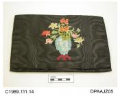 Bag, envelope style clutch bag, black moire, unstiffened, decorated with colourful vase of flowers in cross stitch, lined striped and sprigged silk in shades of grey and ivory, matching small purse containing mirror, approximate width 270mm, approximate