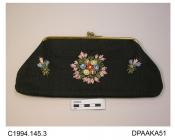 Bag, clutch or pochette type, crisp black fabric, possibly hessian, front decorated with colourful raffia flowers, unlined, on plain gilt frame with cross over snap closure, approximate width 285mm, approximate depth 125mm, c1947