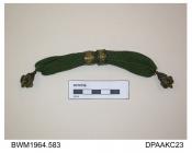 Purse, long, knitted olive green silk, pair embossed pinchbeck or brass rings, each end trimmed with ornate pinchbeck or brass pendant, approximate length excluding pendants 130mm, c1800-1820