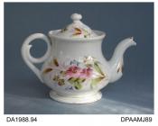 Teapot, hard paste porcelain, pear shape with coiled handle, decorated with painted pink flowers, barley and bright gilding, not marked, possibly made in one of the European countries formerly constituting Bohemia, c1900-1910