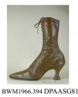 Boots, pair, women's, mid brown leather, front laced with twenty pairs of eyelets and narrow brown laces over full length tongue, needlepoint toe with toecap and fine punched and stitched detail, high curved and waisted Louis heel, metal plate between h