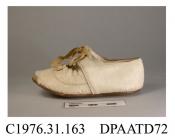 Shoes, pair, child's, white sealskin, latchet tied with two pairs of eyelets and cream silk ribbon, eyelets show signs of verdigris, scallop edged vamp trimmed with small cream silk ribbon bow, broad square toe, lined white kid, flat leather sole, appro