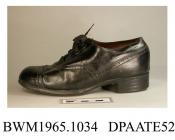 Shoes, pair, child's, black leather, rounded toe with toecap and punched detail at seams, straight rear seam covered shaped strip of leather, front laced with four pairs of eyelets and wide black laces over full length tongue, lined black kid and white 