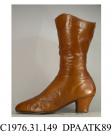 Boots, pair, women's, golden tan kid, laced at inner leg to calf level with nineteen pairs of eyelets and olive green laces over full length tongue, lined cream cotton, curved top with black satin lining woven with maker's name Justesen, 2 Rue de la Pai
