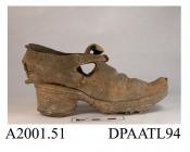 Shoe, one only, child's, leather, latchet tied through pair of holes in centre of broad high tongue, chisel toe, split, straight side and rear seams, hole cut out of heel quarter, high stacked leather heel with metal rim to top piece, straight thick lea