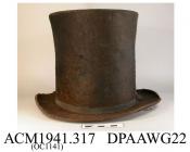 Top hat, hat, men's, black beaver felt, high crown which widens slightly at the top, medium brim, narrow black ribbed silk hatband, crown interlined with white paper and lined with white cotton, top of crown lined with red striped white cotton printed S