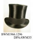 Top hat, men's, part of coachman's livery uniform, black silk plush, high slightly waisted crown, broad black wool frieze hatband, narrow brim with curled sides and edged black ribbed silk ribbon, underside of brim covered with black woollen fabric, dee