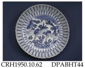 Dish, hard paste porcelain, fluted shape with scalloped rim, sand adhesions to the footrim and radial corrugations to the glaze on the base, decorated with blue painted deer in a landscape; not marked, made in Jingdezhen, Jiangxi Province, China, c1605-