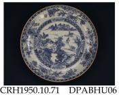 Saucer dish, hard paste porcelain, decorated with a blue painted estuary scene including a junk on a river and a pair of mandarin ducks near a bridge, two painted sprigs under rim, light brown edge; not marked, made in Jingdezhen, Jiangxi Province, Chin