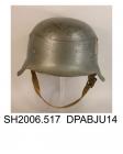 Helmet, men's, military, German Army helmet World War II, M42 moulded steel helmet of grey green colour, short front peak, longer side and rear sections, remains of printed badge on left of crown with spread eagle and swastika motif, inner adjustable sw