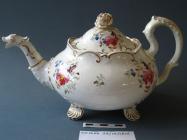 Teapot, bone china, low round shape (Daniels' Shell shape Variation B) with four shell-shaped feet, indented handle, dragon spout and rose knop on lid, decorated with manufacturers' pattern number 5005, enamelled flower sprigs and gilt, not marked, made