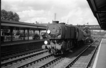 Digital image copy at 800 dpi of an original black and white print photograph retained by donor of Mike Peart, showing a Q1 class locomotive 33018 with a breakdown train at Eastleigh Station.