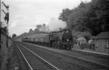 Digital image copy at 800 dpi of an original black and white print photograph retained by donor of Mike Peart, showing a "U" class locomotive 31617 at Shawford Station with train.