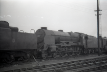 Digital image copy at 800 dpi of an original black and white print photograph retained by donor of Mike Peart, showing a Lord Nelson class locomotive 30850 "LORD NELSON" at the Eastleigh engine sheds.