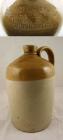 Brown and cream stoneware jug used for wine or spirits and used by Godrich, Roberts & Tanner, Wine and Spirit Merchants, Parchment Street, Winchester. Also stamped with the manufacturer's mark of Powell, Bristol.