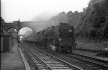 A west country class locomotive 34037 "CLOVELLY" approaching Winchester City Station with an express to Waterloo from Bournemouth West.