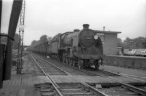 Digital image copy at 800 dpi of an original black and white print photograph retained by donor of Mike Peart, showing locomotive 30503 travelling into Winchester City Station, with a goods train, this locomotive having been built in the 1920's. The number 112 can also be noted on the left-hand side of the vehicle on a white circle.
