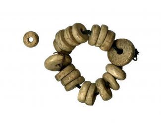 Part of a rosary, consisting of 17 disc-shaped ivory or bone beads on a narrow velvet ribbon. From Hyde Abbey, Winchester, Hampshire.