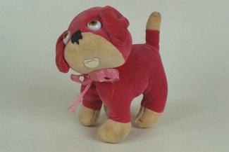Soft toy, dog, pink velvet with cream paws, tail and muzzle, with bead eyes and black stitched nose, wearing a pink bow round its neck, c1920