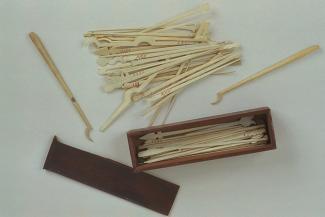 Spellicans, wooden box with sliding lid, containing 4 ivory rods with hooks at one end and 67 ivory rods pointed at one end and cut to various shapes at the other, many of the rods have Roman numerals marked on them in red
This is probably more than one