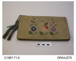 Bag, rectangular, fold-over, undyed linen on stiffened base, front with applique flowers, possibly hollyhocks, in soft shades of blue, pink, red and mauve, rear face has a yellow flower, all edged with fine blue braid which also forms handle strap and d