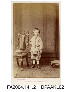 Photograph, Sir Henry Tichborne, as a child aged 4 or 5 years, standing by a chair, taken by P Skeolan of Cheltenhamvol 1, page 3