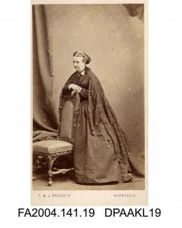 Photograph, Mrs Katherine Radcliffe standing by a chair, taken by T and J Holroyd of Harrogatevol 1, page 4 - The Family and Connections