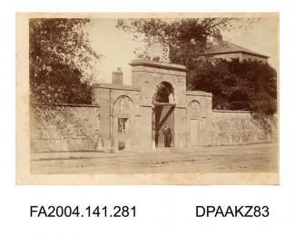 Photograph, the main entrance to the barracks at Clonmel with a soldier standing in the archway, probably taken by R Vervega, 1869vol 1, page 35