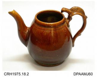 Teapot, earthenware, lid missing, pear shape with debased eagle design handle, full Rockingham-type glaze, not marked, not attributed, c1860-1870