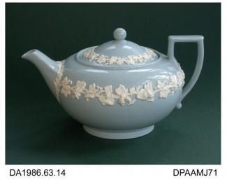 Teapot, creamware, low round shape (Wedgwood's shape no 146) with angular handle, pale blue ground with white grape-vine decoration in relief, printed Queen's ware mark and impressed date and factory marks on base, made by Josiah Wedgwood and Sons, Barl