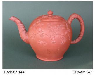 Teapot, or punch pot, red stoneware, inverted pear shape, decorated with applied sprigs of prunus and an exotic bird, the reeded spout and handle spring from acanthus mouldings, pseudo-Chinese seal mark on base, attributed to the Foley Pottery, Fenton C