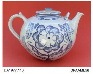 Teapot, earthenware, tin-glazed, globular shape with supplementary handle on shoulder, decorated with a flower and quill-pen design in blue, ACS monogram and year mark in green on base, made by Alan Caiger-Smith, Aldermaston Pottery, Aldermaston, Berksh