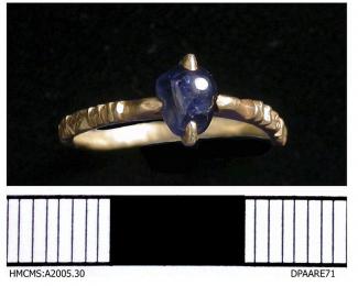 Sitefinds, stray find, Medieval gold ring with a blue stone dating to the late C13th-early C14th.The slender highly decorated hoop is divided into many facets creating lozenge fields into which crosses have been engraved, between each faceted lozenge ar