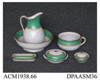 Toilet set, consisting of ewer and basin, sponge and soap dishes, toothbrush box and chamber pot, white earthenware, decorated with wide green bands and printed borders painted in yellow enamel and gilt; red painted pattern number D2038 on each part, an
