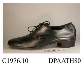 Shoes, pair, men's, black leather, squared toe, laced with two pairs of holes and round laces over full length tongue, curved side seams, straight rear seam covered with triangular piece of matching leather, unlined, printed inside Elliott in Europe, ot