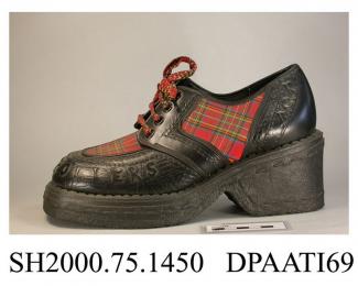 Shoes, pair, women's, decorated in the Bay City Rollers style, black synthetic material trimmed tartan fabric, laced with four pairs of eyelets and colourful braided laces over a full length tartan tongue, one lace is missing and has been replaced with 