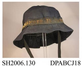 Hat, WREN's uniform, soft navy blue twilled cotton, soft crown in six sections with covered button to centre, narrow brim with stiffening and topstitched detail, black silk cap tally with Commander in Chief woven in gilt thread, black cotton tape ties, 
