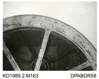 Photograph, black and white, showing a mill wheel, Tasker and Co's name cast on wheel, Enford Mill, Enford, Hampshire