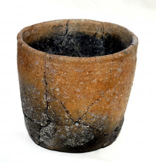 Sitefinds, iron age saucepan pot with straight sides and decoration comprising an applied cordon of diagonal lines around the neck of the pot and holes in the base, excavated at Danebury Iron Age Hill Fort, Nether Wallop, Hampshire, 1971.  From Danebury