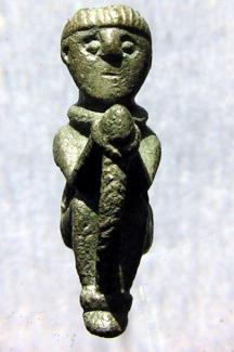 Sitefinds, Roman copper alloy bound figurine, metal detector find near Fullerton? , Wherwell, Hampshire.  A small figure of a bound and trussed captive with Celtic features and hairstyle.  The item is perforated for suspension. It presumably has somethi