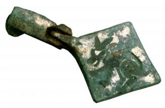 Copper alloy harness pendant originally tinned or gilt and enamelled with a griffin motif.
