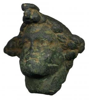 Cast copper-alloy head of a Roman statuette found by metal detector in the Owslebury area, Hampshire.