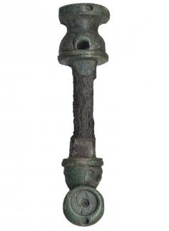 Copper alloy and iron linch pin, Spratling's Group III type, the iron shaft of the pin capped with a bronze terminal shaped like an inverted pedestalled vase or baluster. Traces of red glass survive in several of the setting holes. Mid-Late Iron Age. Fo