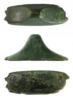 Early Anglo-Saxon cast copper-alloy dagger or seax pommel of the "cocked-hat" type, found at Pudding Farm, Headbourne Worthy, Hampshire. An incomplete pommel, broadly rectangular in plan, with slightly bowed longer edges. The two shorter edges are both 