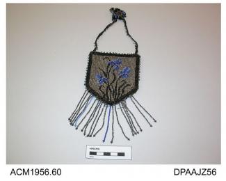 Bag, small, shield shaped, slightly stiffened, front of black material closely beaded with design of irises in blue and black on silver ground, outer border of black beading, edges trimmed silver and black beads, base trimmed long beaded fringe in silve